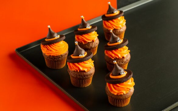 Tray of Halloween cupcakes with orange frosting and chocolate decorations