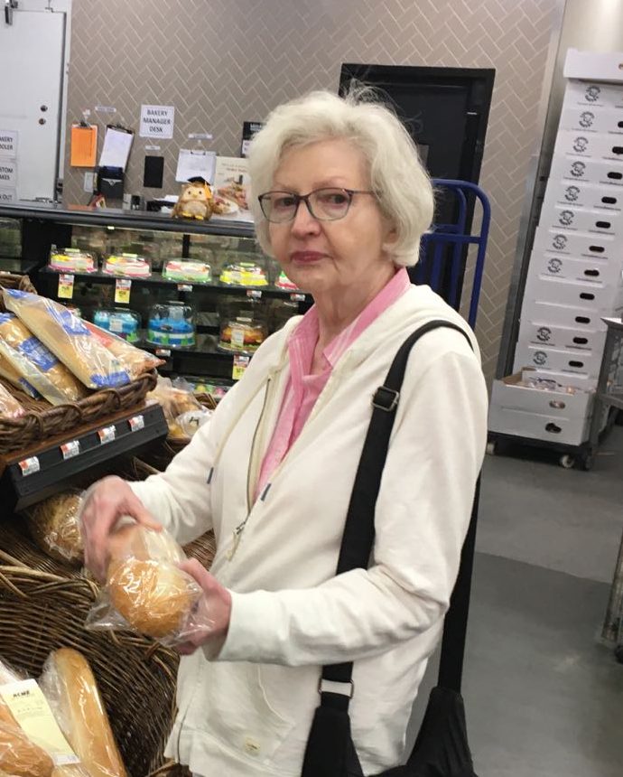 Fluffy choosing a loaf of bread at the bakery counter